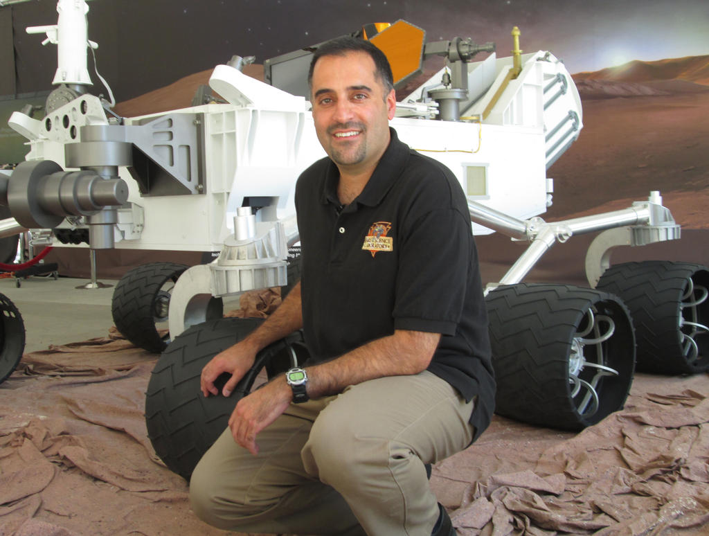 Ashwin Vasavada, the newly announced program scientist for NASA&#039;s Mars Science Laboratory mission. A full-scale model of the Curiosity rover flanks him. 