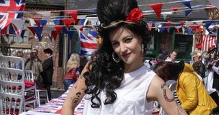 Kylie went all out (check out those fake tattoos) when she donned a beehive and huge gold hoops to Corrie's jubilee party as the late, great Amy Winehouse.