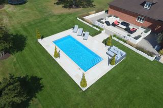 outdoor pool with surrounding lawn by SPATA Member – Centurion Leisure