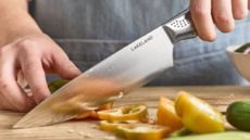 Someone slicing vegetables with a Lakeland knife 