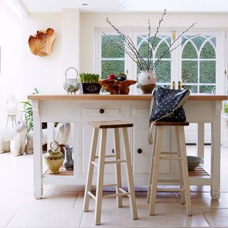 kitchen area with white counter table with stool chair
