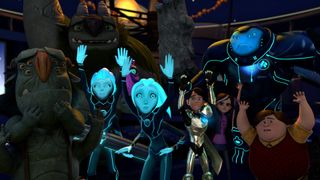 (L to R) Blinkous Galadrigal, Prince Krel Tarron, Princess Aja Tarron, Jim Lake Jr., Claire Nuñez, Commander Varvatos Vex, and Toby Domzalski stand with their hands up in an episode of 3Below: Tales of Arcadia.