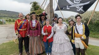 The Midsomer Mummers in costume for The Pirates of Penzance stand together as a group in Midsomer Murders