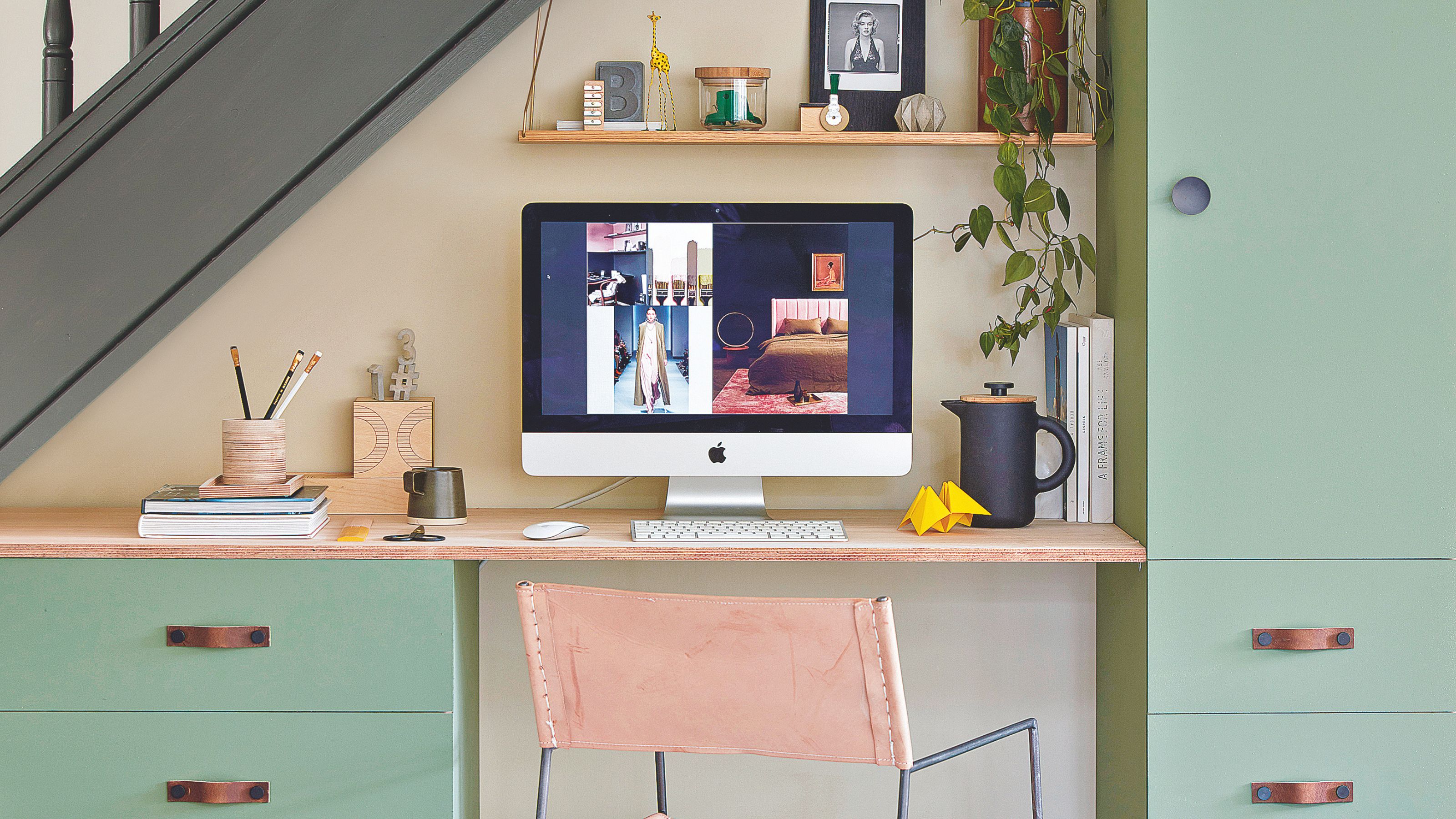 Under the stairs desk with green storage either side of a desktop computer