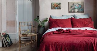 Merlot red bedlinen in a pale pink bedroom showing how to use the Pntone Color of the year 2023 in homes