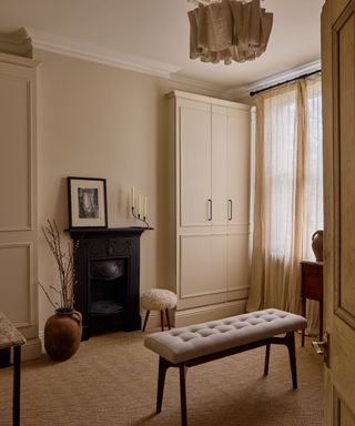 dressing room with neutral walls and cabinets, jute carpet, neutral cozy decor