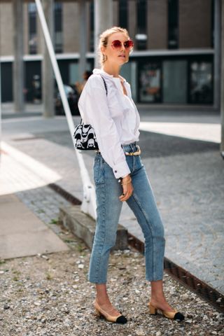 woman wearing button up shirt, jeans, and slingback heels