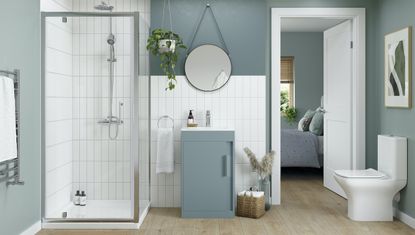 blue bathroom with wood vinyl flooring and white tiles with bedroom door open