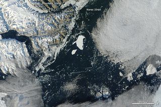 This iceberg, named PII-2012, is beginning to go to pieces off the coast of northwest Greenland after breaking from the Petermann Glacier in mid-July.