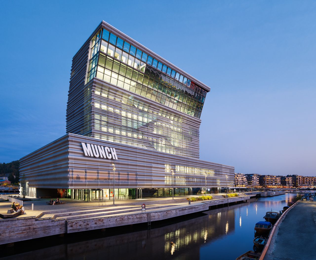 The new Munch Museum in Oslo standing over the water in all its illuminated glory in the dusk