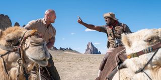 The Rock and Kevin Hart riding camels in Jumanji: The Next Level