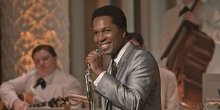 Sam Cooke (Leslie Odom Jr.) smiles as he holds a microphone in 'One Night in Miami'