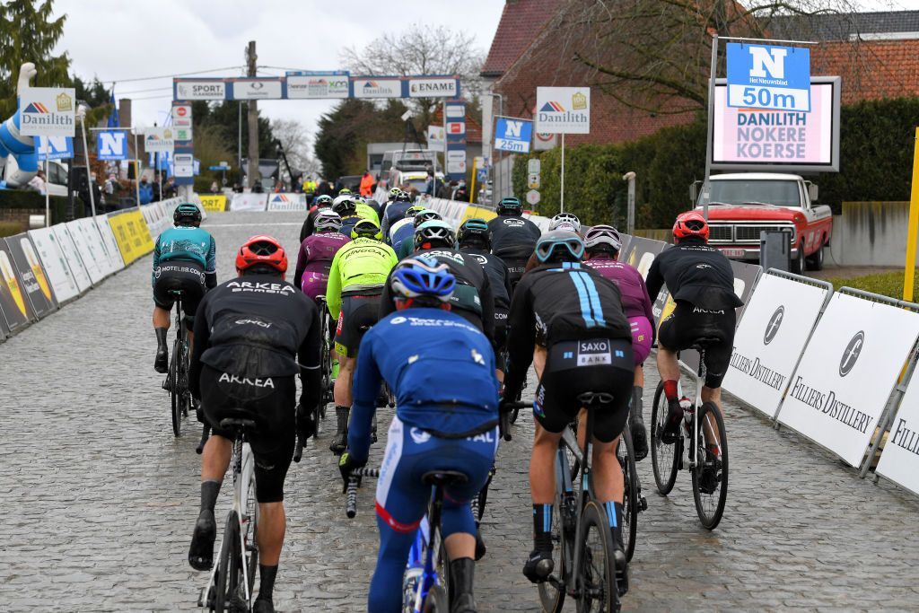 NOKERE BELGIUM MARCH 17 The peloton during the 75th Nokere Koerse Danilith Classic 2021 Mens Elite a 1955km race from Deinze to Nokere Cobblestones Rain Detail view NokereKoerse on March 17 2021 in Nokere Belgium Photo by Luc ClaessenGetty Images