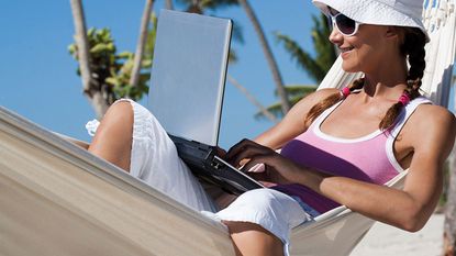 Woman in a hammock with a laptop