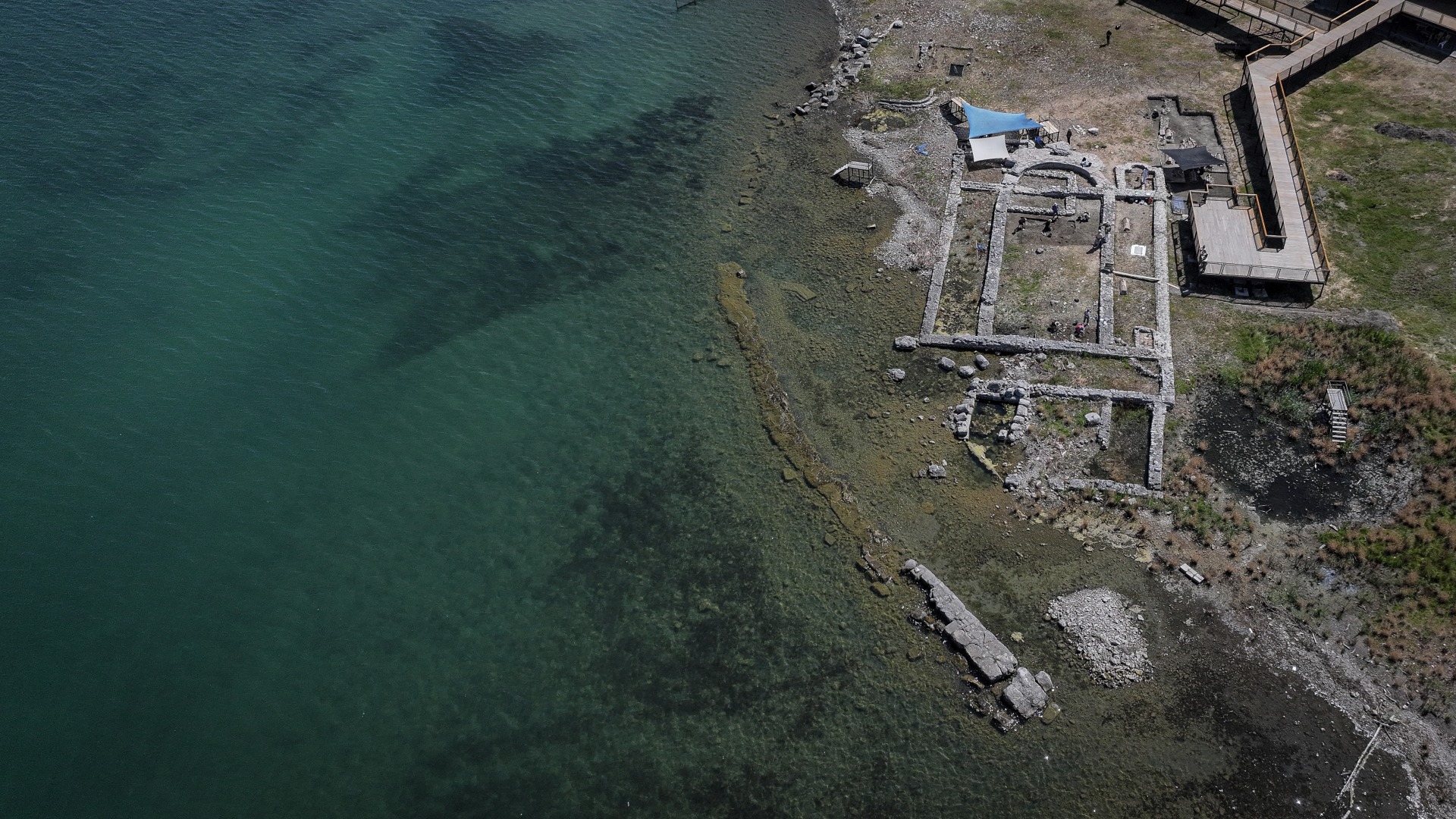 aerial shot of a coast with archaeological walls coming out