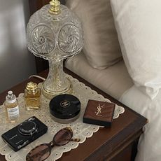 A chic bedside table with a Burberry and Maison Margiela Replica perfume on