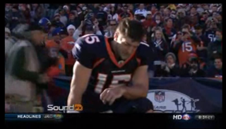 Tim Tebow prays before a Broncos game