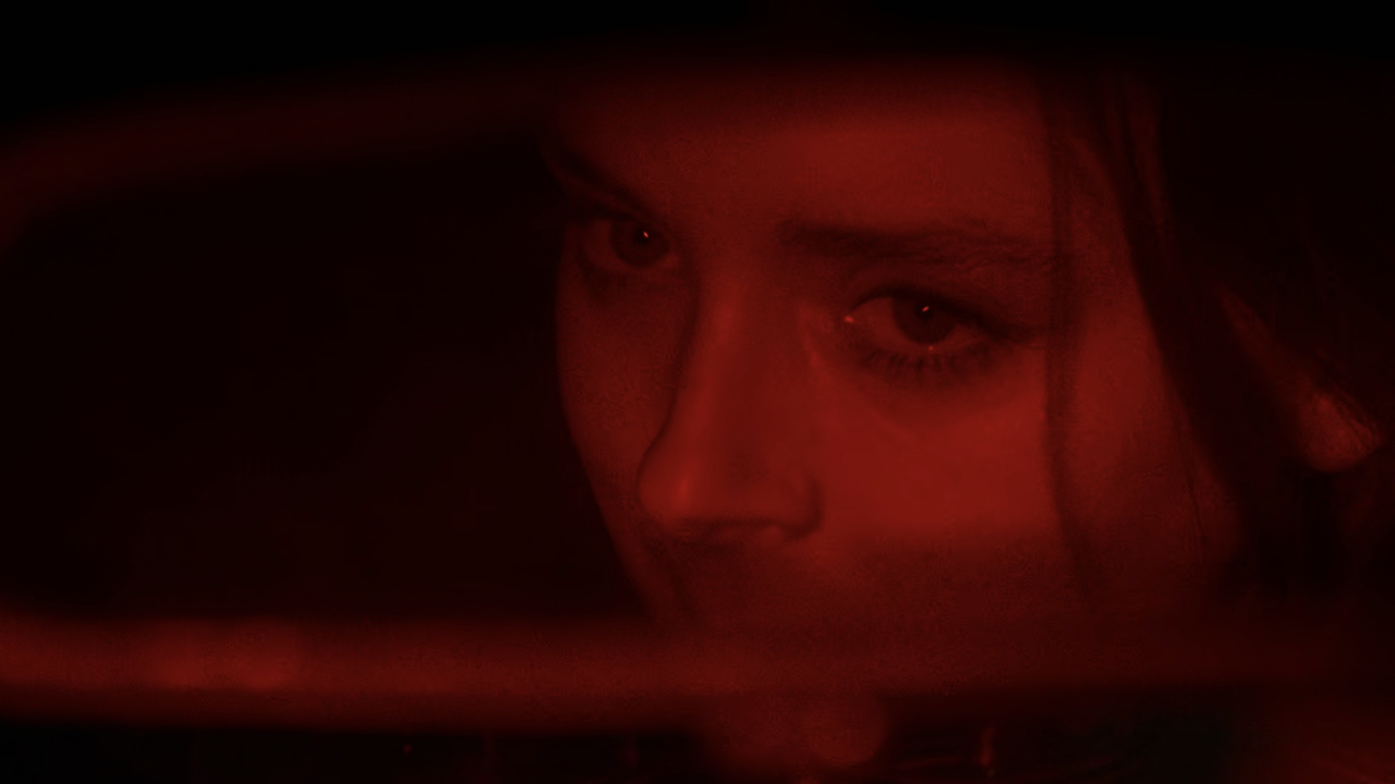 Screenshot of Beatrice in the rearview mirror in It's What's Inside