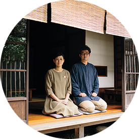 A couple sitting on mat