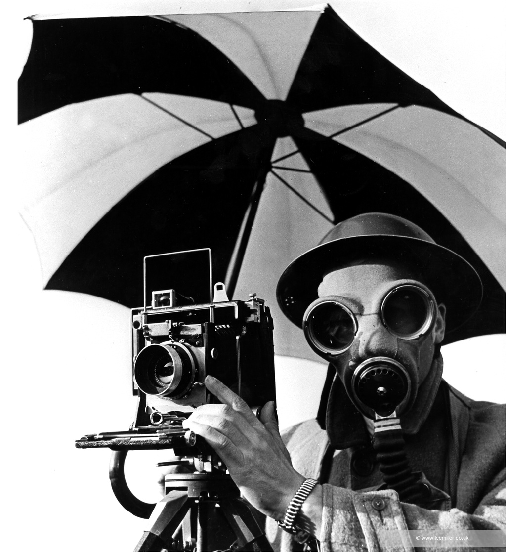 Lee Miller photograph of man in gas mask with camera, beneath umbrella