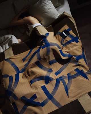 Woman lying in bed with blanket on her