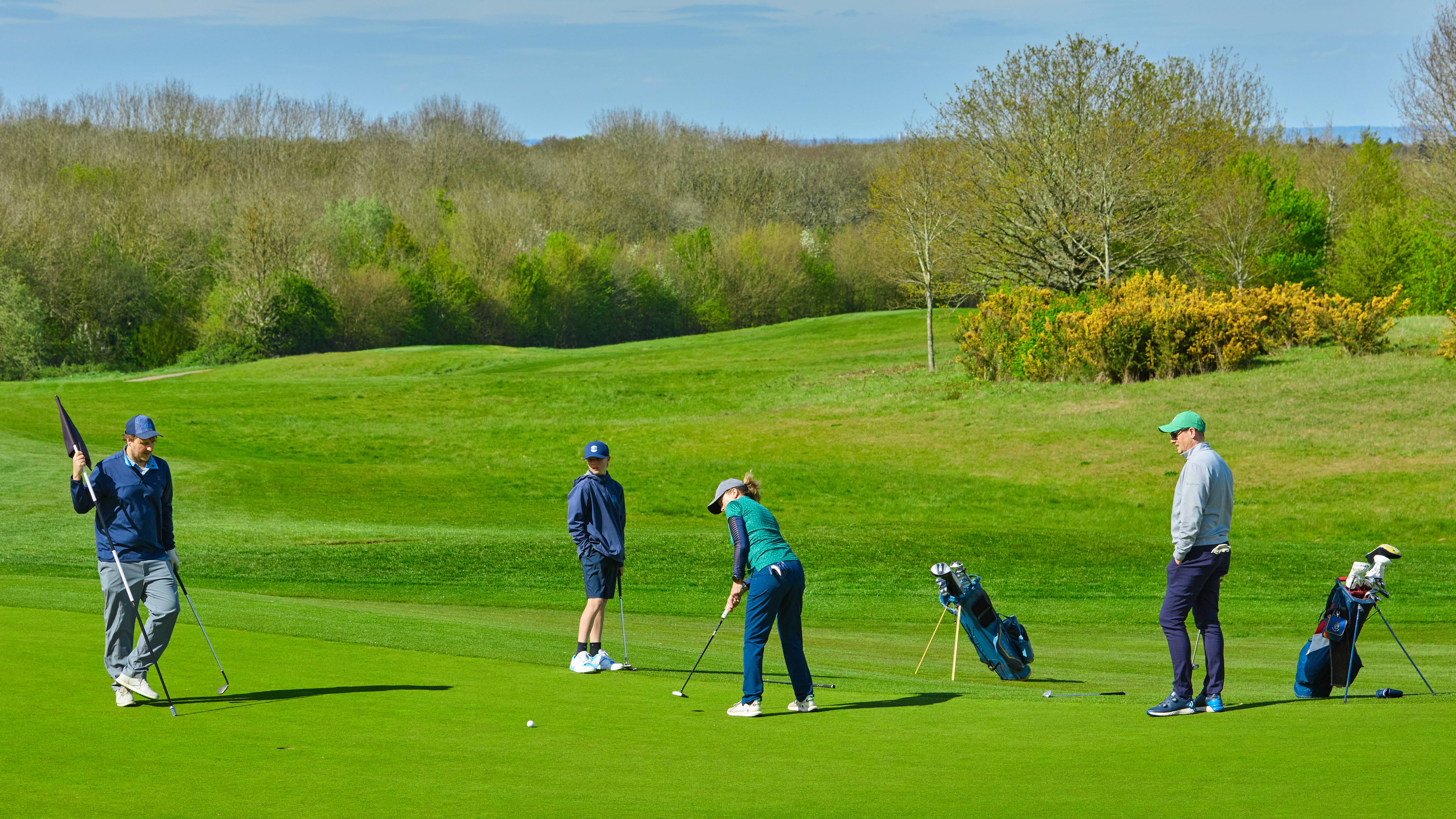 Four golfers on the green