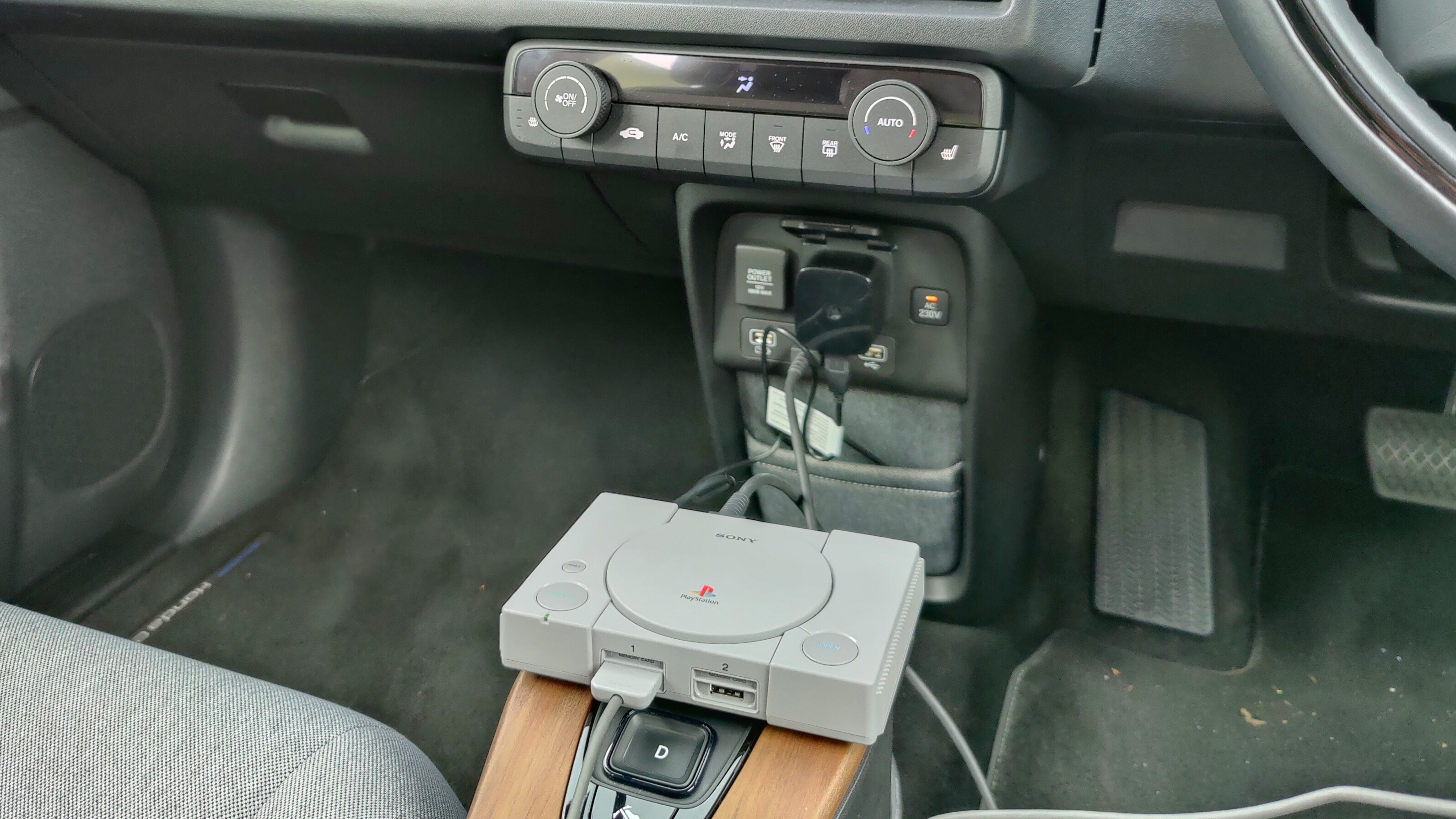 PlayStation Classic plugged into the Honda e