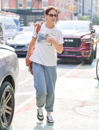 katie holmes wears gray sweatpants and a white graphic tee while out in nyc