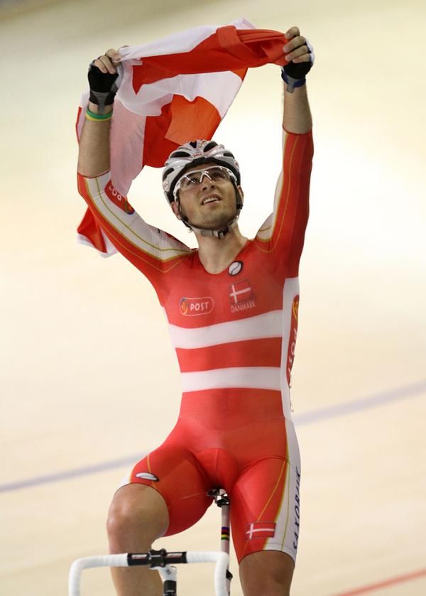 Alex Rasmussen hoists the Danish flag high after he won the men's scratch race