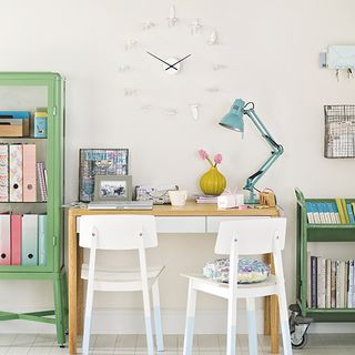 white room with study table and book shelf