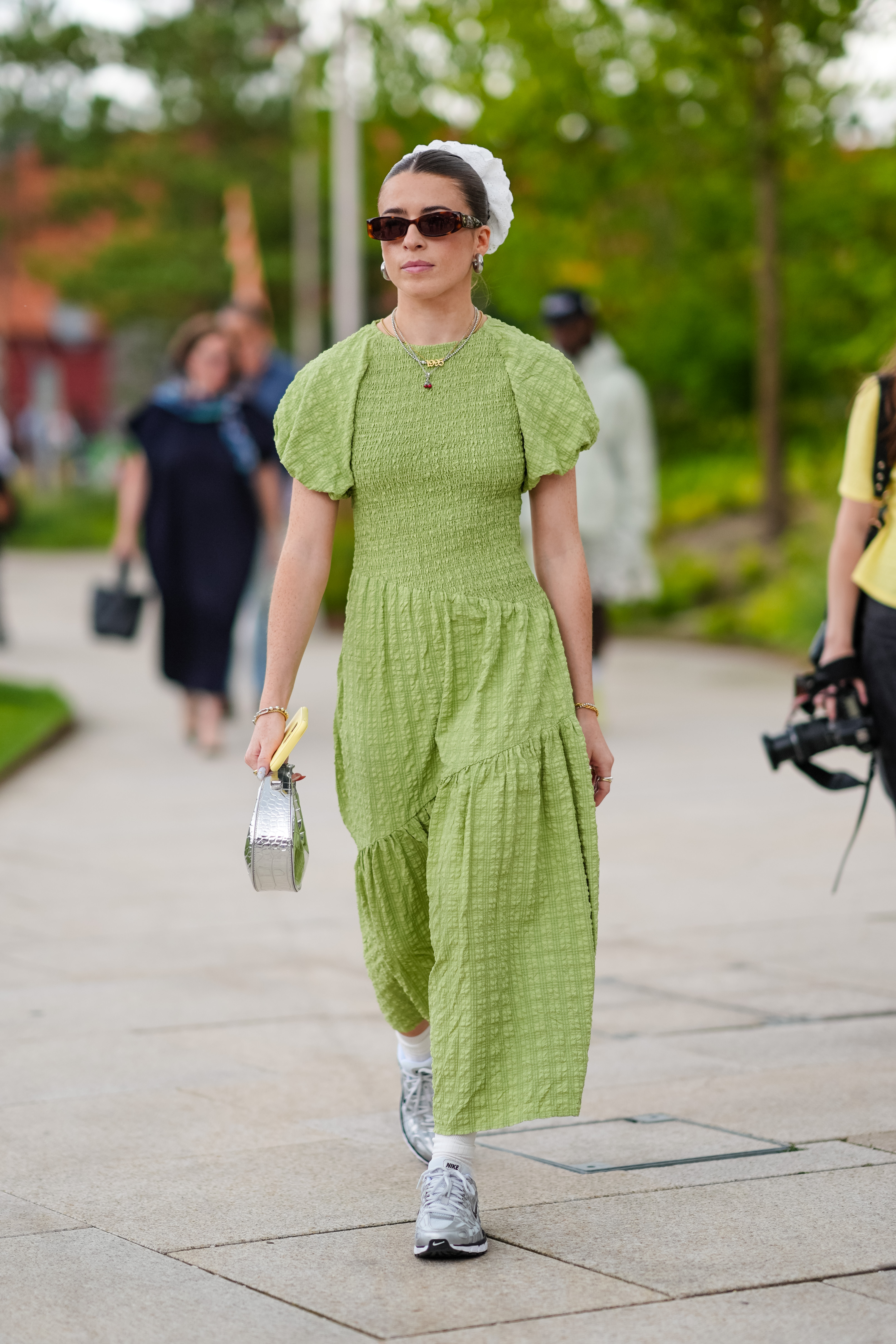 green dress, silver bag, and gray shoes