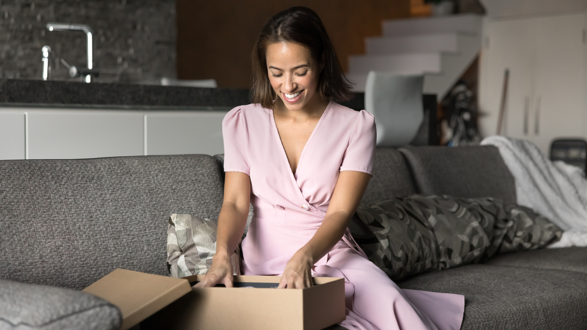 A woman unboxing an item.