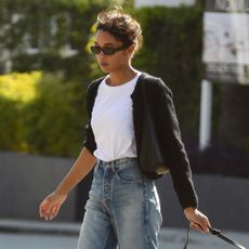 Laura Harrier wears jeans and flats.