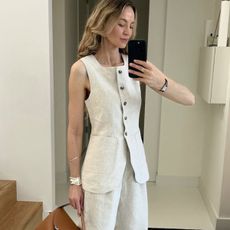 A woman wearing a linen vest and pants