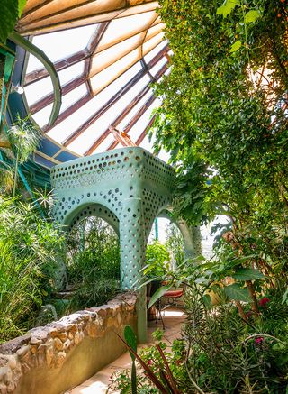 Earthship community in Taos showing colourful off grid homes nestled into the desert earth