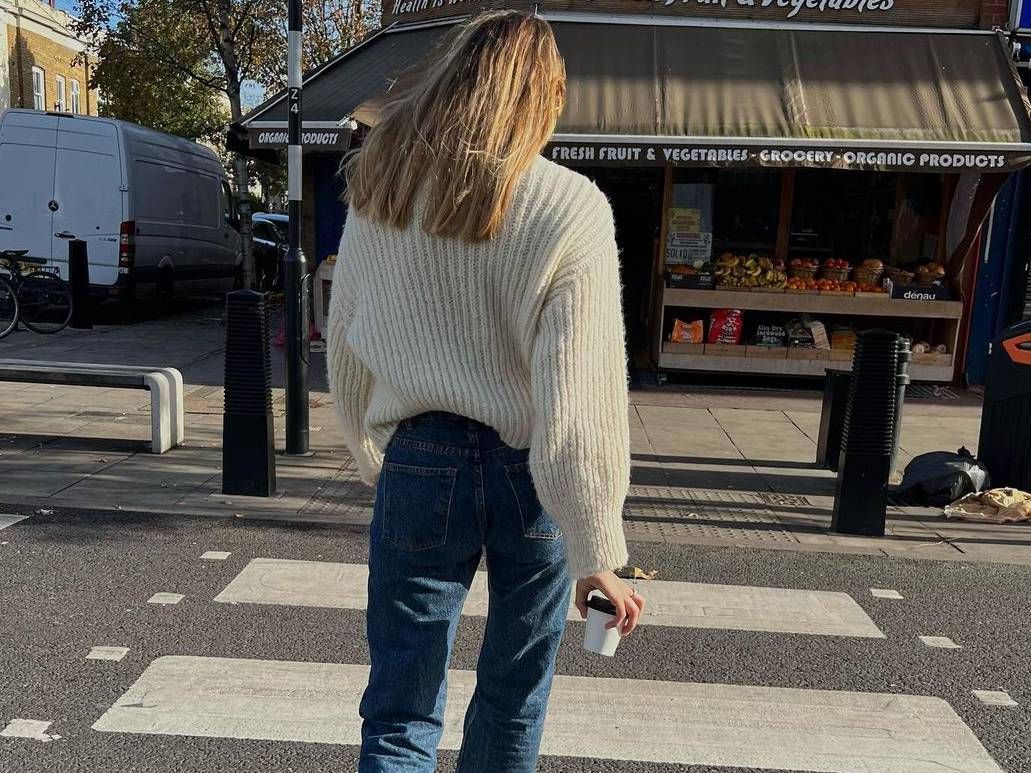 Lizzy Hadfield in jeans and beige jumper