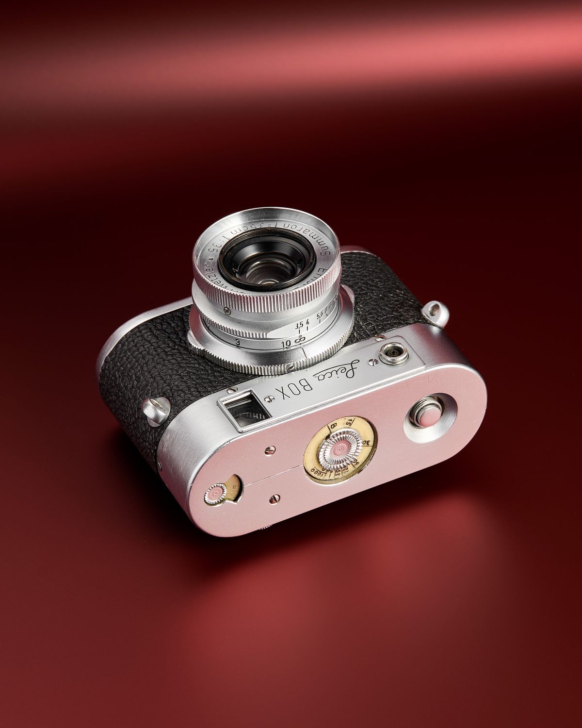The working Leica Box camera prototype from the mid 1950s on a red background