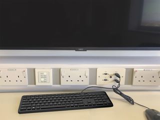 Extron switches plugged into outlets.