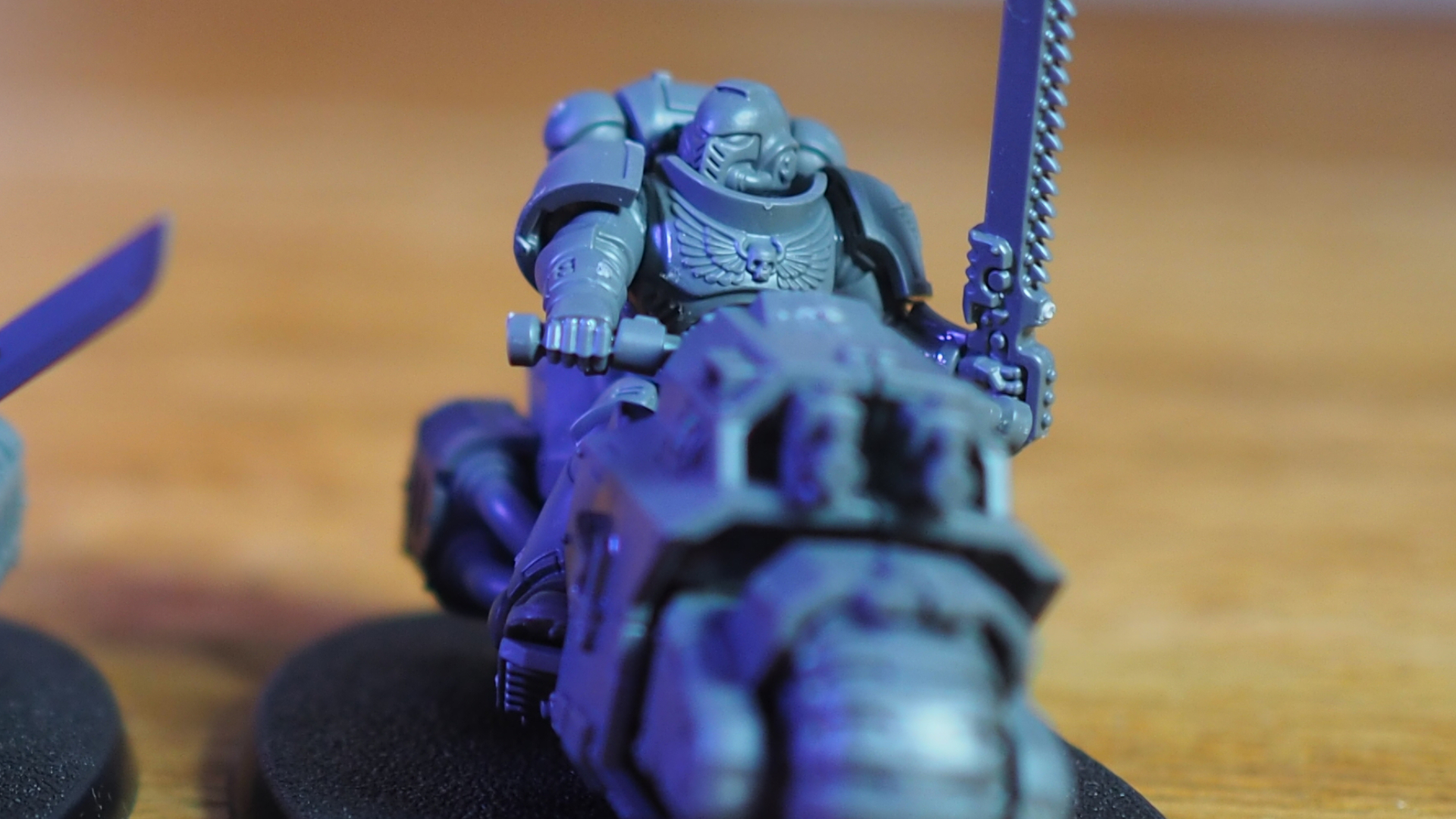 Warhammer 40K Space Marine Outrider on a bike, on a wooden surface