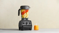 Vitamix E520 making a tropical fruit smoothie on a modern countertop 