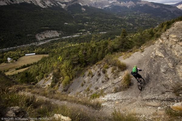 A racer flows downhill on singletrack during day 4 of the Trans-Provence