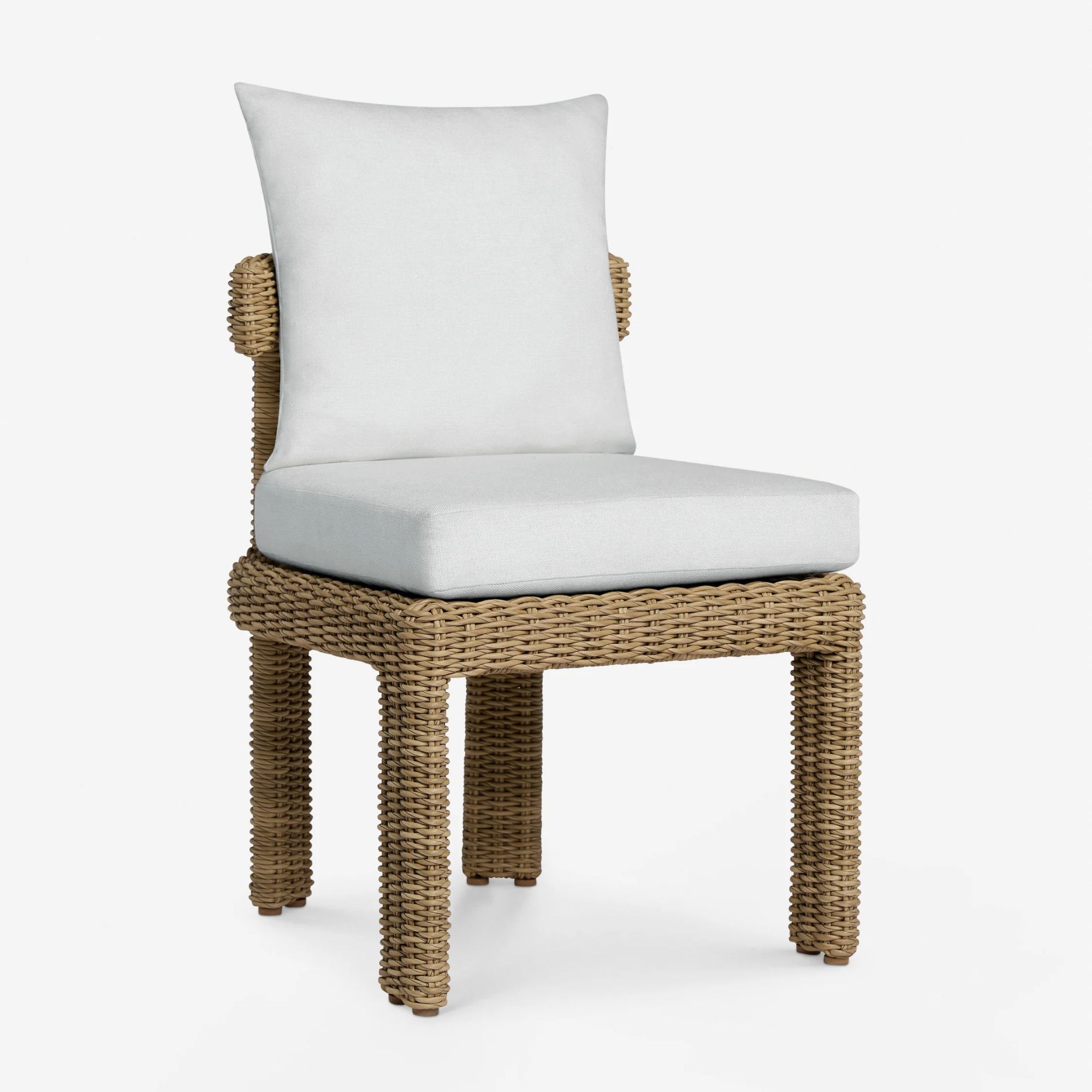 Rattan outdoor dining chair with white pillows