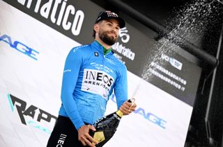 Filippo Ganna celebrates winning the opening stage of the 2025 Tirreno-Adriatico wearing the blue leader's jersey