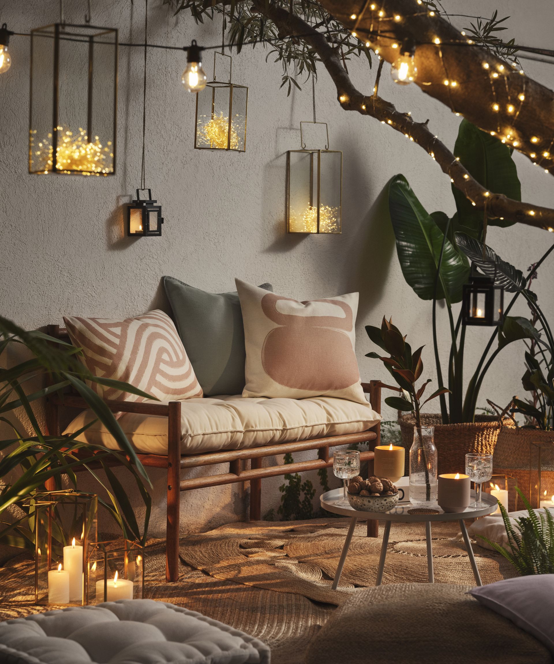 garden living area with outdoor fairy lights and outdoor lanterns and candles