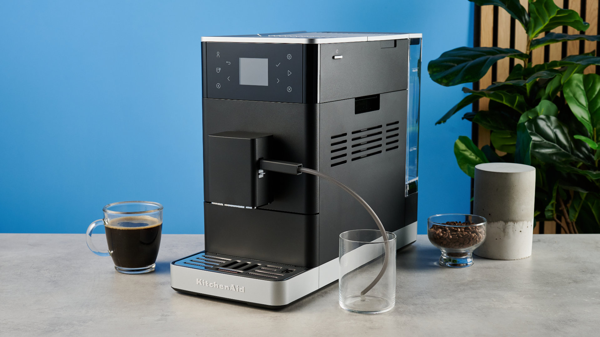 the kitchenaid kf3 superautomatic coffee machine photographed against a blue tom's guide background