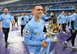 Phil Foden poses with the Premier League trophy after Manchester City's title win in May 2021.