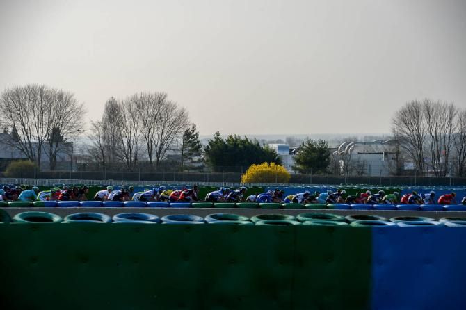 The peloton speeds into the Magny-Cours circuit
