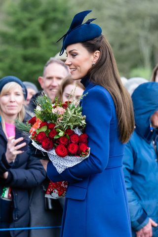 Kate's Christmas Day look is as chic as we imagined it would be, with the Princess of Wales opting for one of her favourite brands—Alexander McQueen—for the focal point of her outfit. The Princess wore an electric blue coat with matching Gianvito Rossi heeled boots and a simple black turtleneck jumper. A striking Juliette millinery hat and some dazzling diamond earrings completed the look. Princess Catherine's earrings held a special significance, as they previously belonged to her later mother-in-law, Princess Diana. The striking set is crafted from diamonds and sapphires and was a firm favourite with the former Princess of Wales. Kate's hair was worn half up half down, showing off the stunning jewellery.