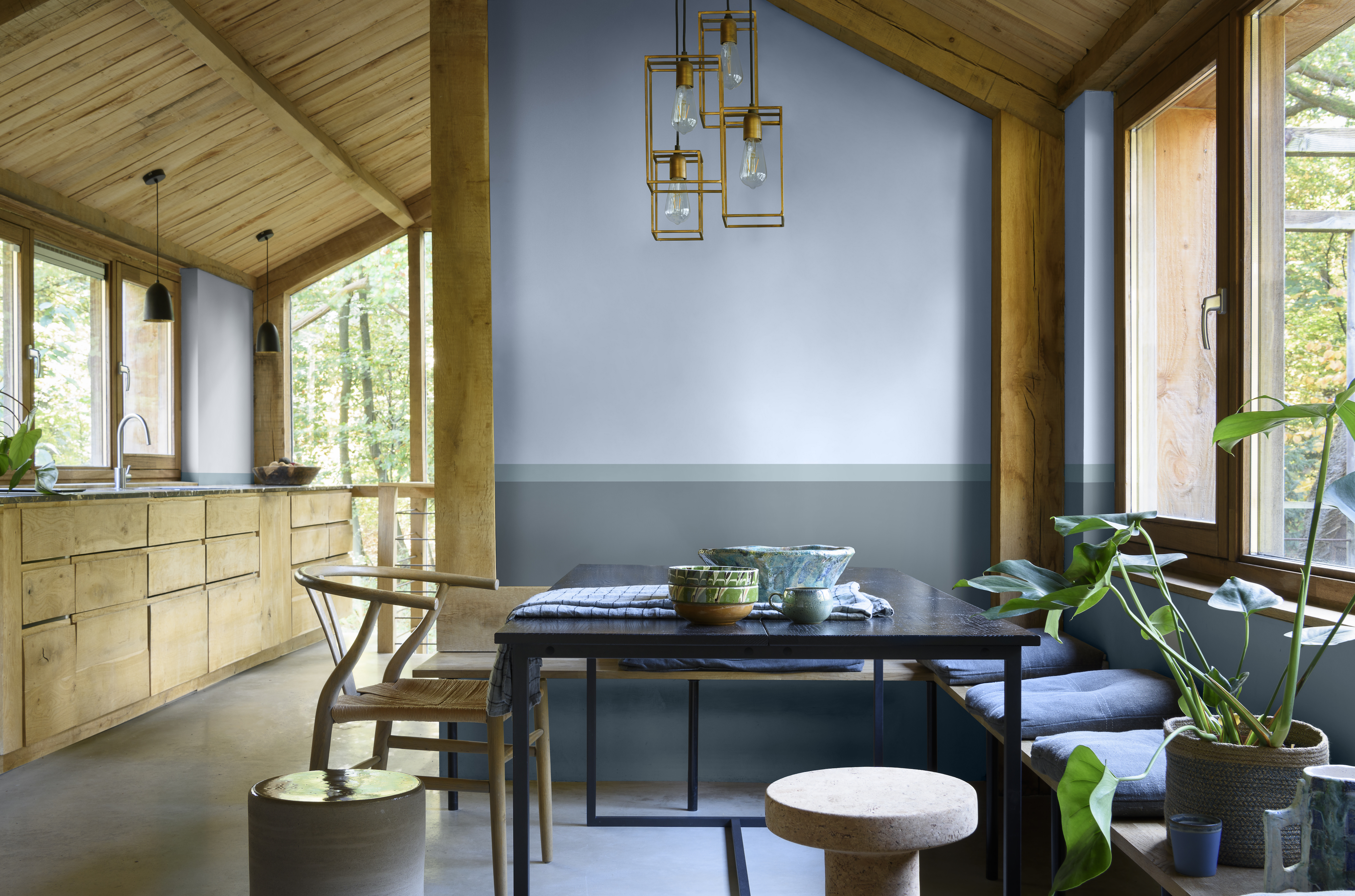 rustic kitchen diner, with wood kitchen cabinetry, beams, wooden floors, black table, benches