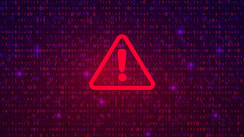 Data breach concept image showing a red-colored warning symbol imposed over glowing binary code.